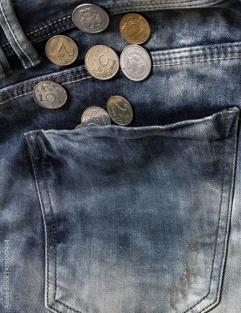 coins in blue jeans pocket close-up, finance and currency concept coins in blue jeans pocket close-up, finance and currency concept