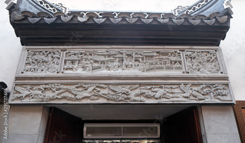 Richly carved stone bas-relief plaque on the doorway of the house in the Grand Canal, ancient town of Yuehe in Jiaxing, Zhejiang Province, China photo