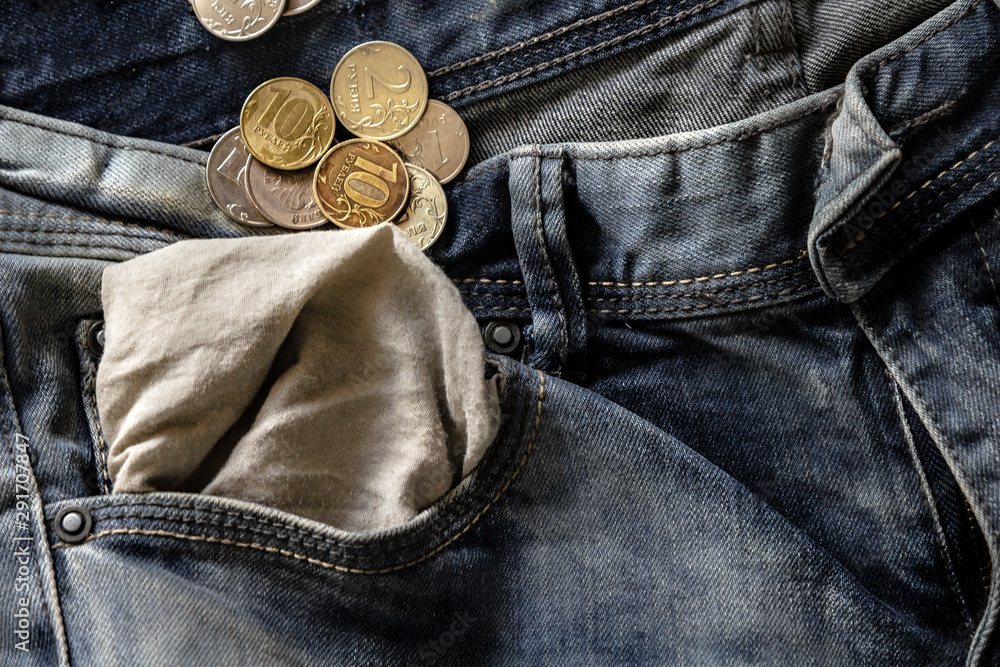 coins in jeans pocket turned inside out close-up, finance and currency concept coins in jeans pocket turned inside out close-up, finance and currency concept
