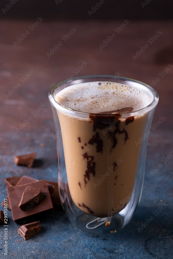 Glass cup of coffee latte with chocolate on stone dark table Glass cup of coffee latte with chocolate on stone dark table