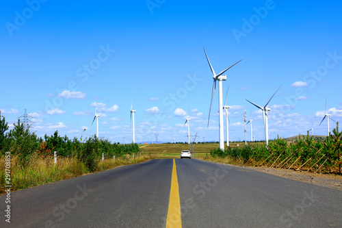 Asphalt road and wind turbines