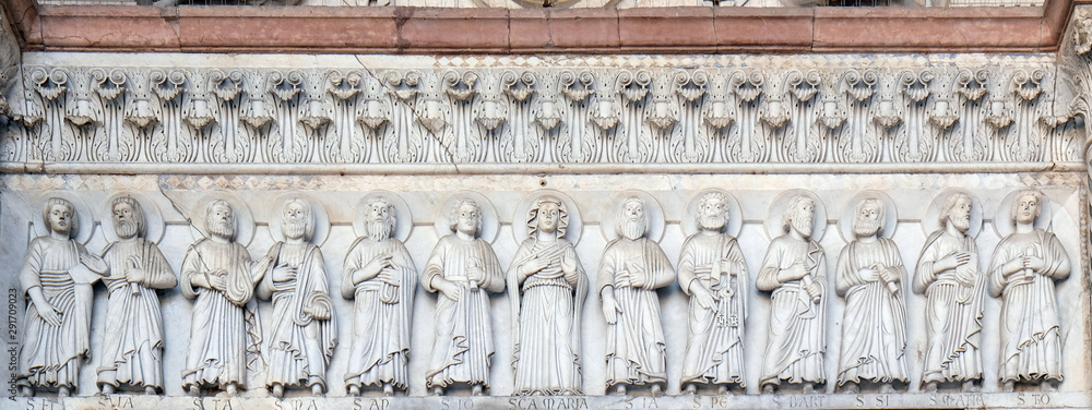 The central portal of the Cathedral of St Martin in Lucca. Lunette depicts the Virgin Mary with Apostles, Lucca, Italy.