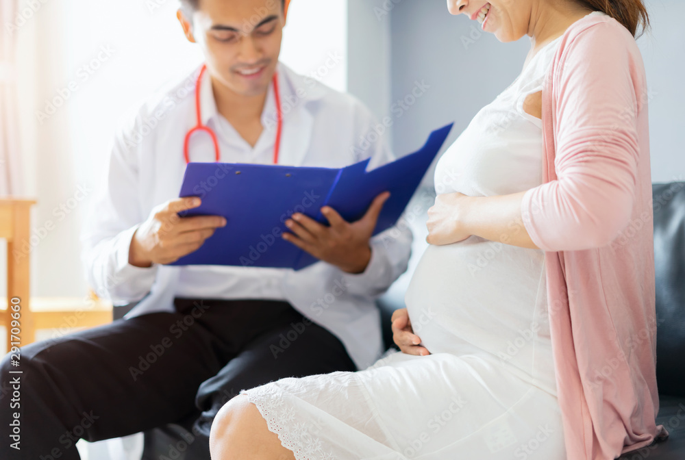 Obraz premium Happy pregnant woman visit doctor at hospital for pregnancy consultant at ultrasound scanning office