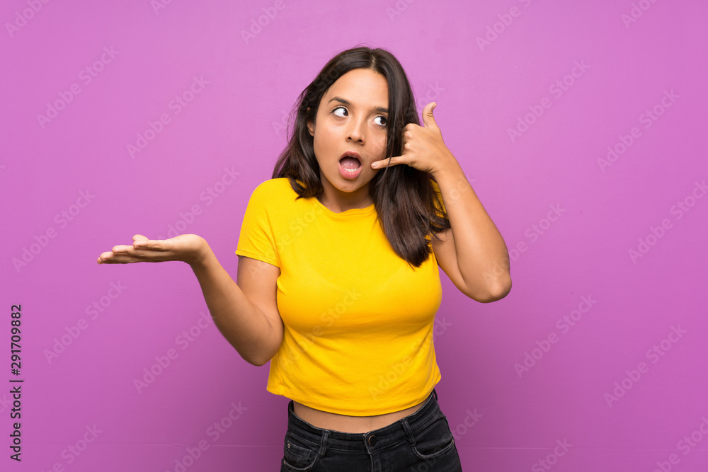 Young brunette girl over isolated background making phone gesture and doubting Young brunette girl over isolated background making phone gesture and doubting