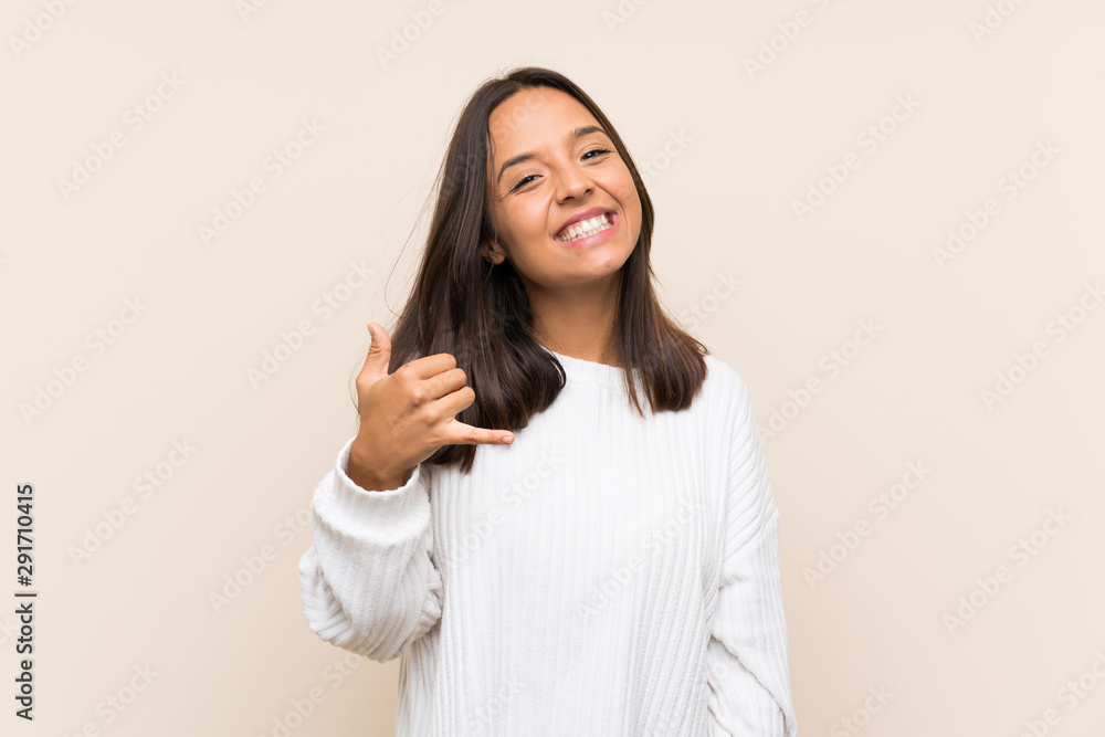 Young brunette woman with white sweater over isolated background making phone gesture Young brunette woman with white sweater over isolated background making phone gesture