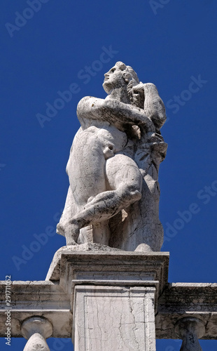 Statue at the top of National Library of St Mark`s Biblioteca Marciana, Venice, Italy