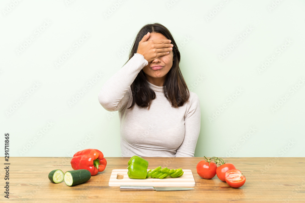 Young brunette woman with vegetables covering eyes by hands Young brunette woman with vegetables covering eyes by hands