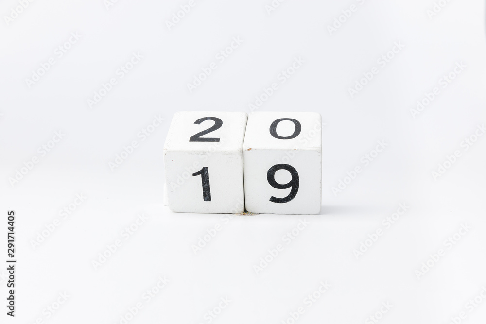 Business and design concept - geometric floating wooden cube on white background. 2019 2020 years. Business and design concept - geometric floating wooden cube on white background. 2019 2020 years.