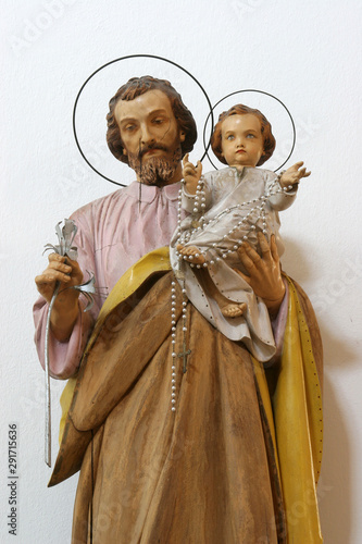 Saint Joseph holding child Jesus, statue on the altar in the Church of Blessed Virgin of Purification in Smokvica, Korcula island, Croatia photo