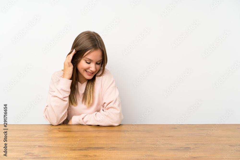 Teenager girl in a table laughing Teenager girl in a table laughing