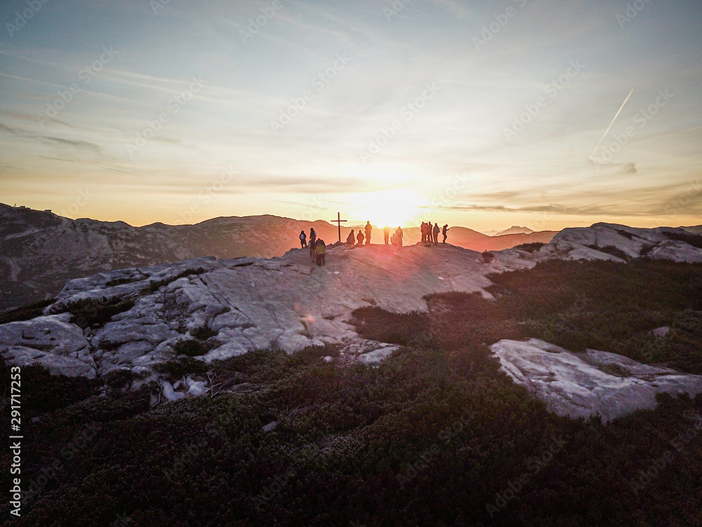 Group of people watching sunrise on a mountain