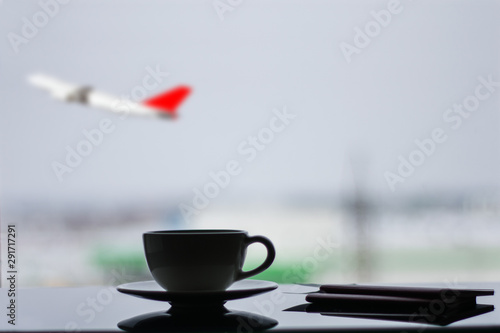 waiting for departure at the airport with a cup of coffee