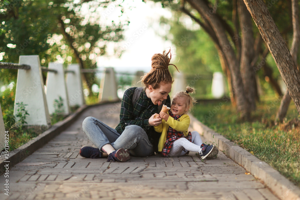 hipster mom and child with ice cream outside hipster mom and child with ice cream outside
