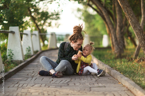 hipster mom and child with ice cream outside