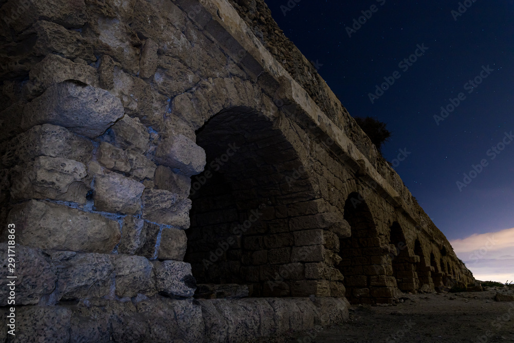 Night  view of the remains of an ancient Roman aqueduct located near Caesarea in Israel