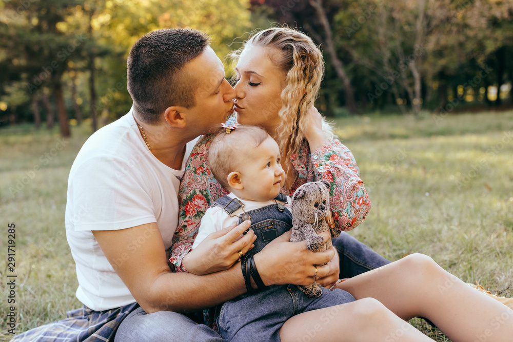 Happy family father, mother and child daughter outdoor enjoying sunset - Image Happy family father, mother and child daughter outdoor enjoying sunset - Image