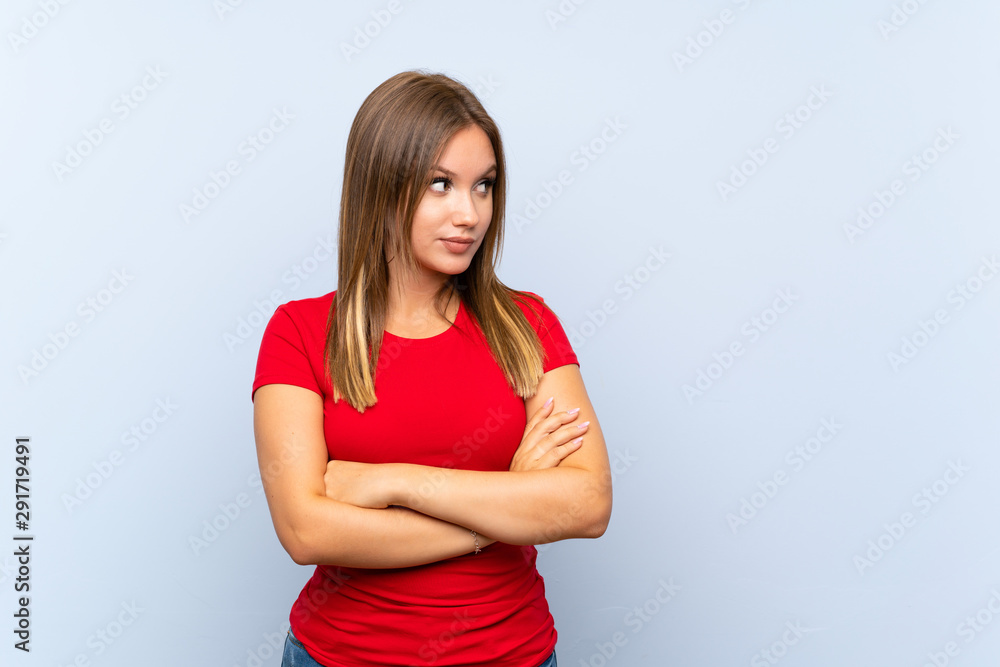 Teenager girl over isolated blue background thinking an idea Teenager girl over isolated blue background thinking an idea