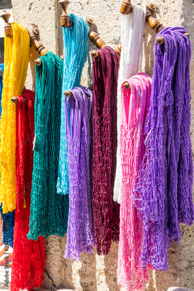 Colourful net bags hanging up outside a shop i
