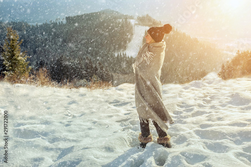 Happy woman traveler on the snowy of mountain look on the nice w