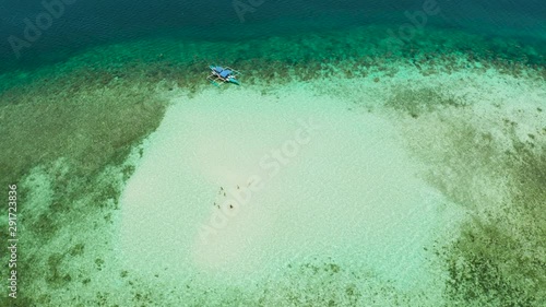 Sandbar on a coral reef. Atoll with turquoise water and sandy bottom, top view. Balabac, Palawan, Philippines. Place for snorkeling.