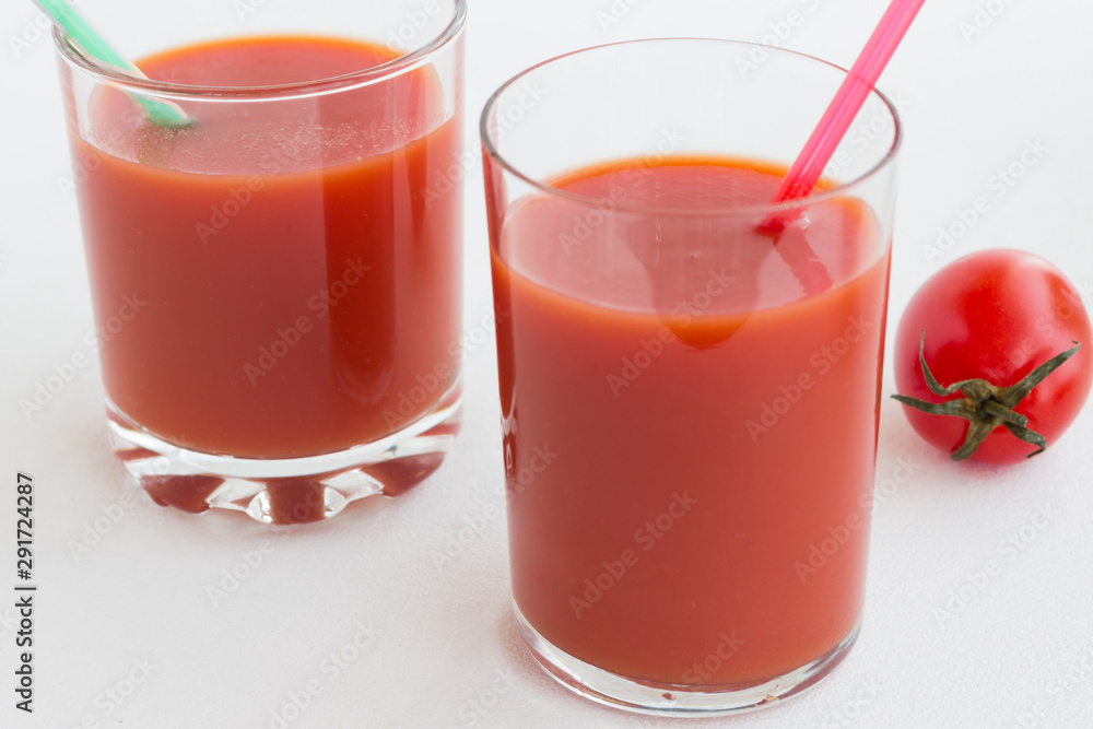 Two glasses of tomato juice on a white background Two glasses of tomato juice on a white background
