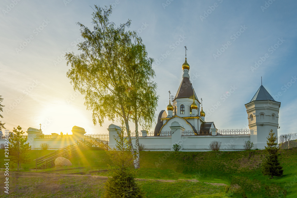 Orthodox Church, domes, against the sky. Novo-Uspensky monastery in Krasnoyarsk, Russia. Clouds, a fragment of the building