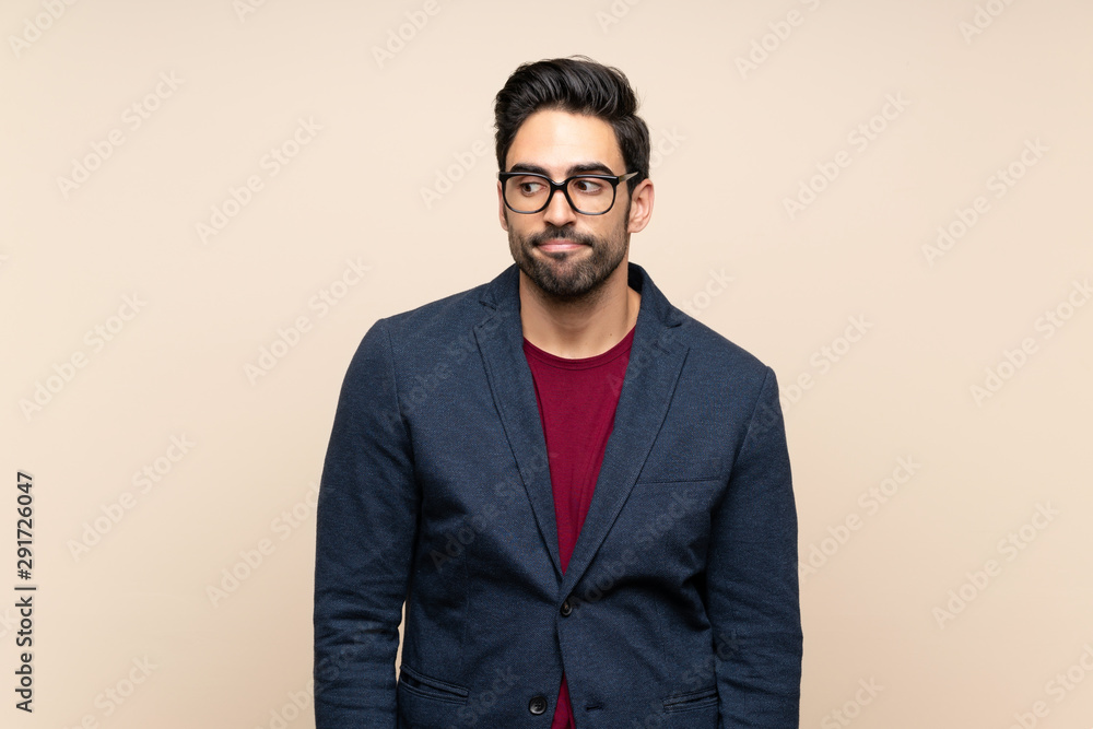 Fototapeta premium Handsome young man over isolated background making doubts gesture looking side