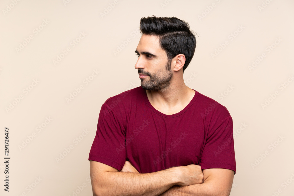 Handsome young man over isolated background looking side Handsome young man over isolated background looking side