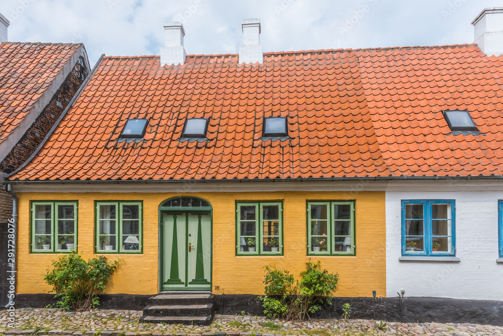 the facade of an old idyllic house in a cobbled street, island of Aero, Denmark,