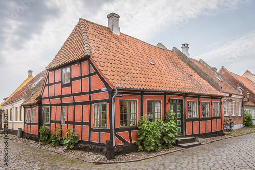 An idyllic half-timbered house in the corner of two cobblestone-streets