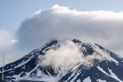 Beautiful autumn volcanic landscape - view of snow-capped cone of stratovolcano Bolshaya Udina Volcano in Klyuchevskaya Group of Volcanoes.
