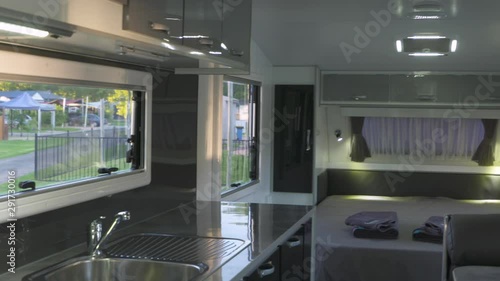 A panning shot showing the classic design of this modern caravan including the kitchen and sleeping arrangements.
