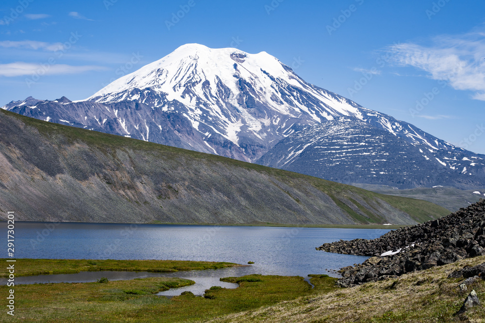Picturesque summer volcanic landscape of Kamchatka Peninsula: view of active Volcano.