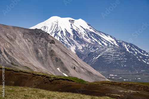 Picturesque summer volcanic landscape of Kamchatka Peninsula: view of active Volcano.