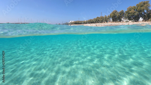 Fototapeta Naklejka Na Ścianę i Meble -  Above and below underwater photo of turquoise clear sea of Ammos sandy beach near port of Koufonisi island, Small Cyclades, Greece