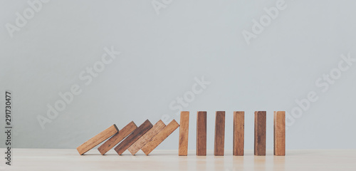 Stop wooden domino business crisis effect or risk protection concept
