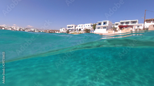 Fototapeta Naklejka Na Ścianę i Meble -  Above and below underwater photo of turquoise clear sea of Ammos sandy beach near port of Koufonisi island, Small Cyclades, Greece