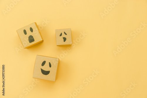 Table top view of decoration Happy Halloween day background holiday concept.Flat lay accessories essential object to party the jack o lantern on gift box on yellow paper.Space for creative design.