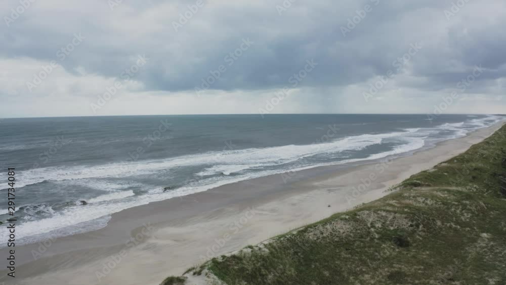 Gloomy flyover of coast with waves crashing. Dune 4k Gloomy flyover of coast with waves crashing. Dune 4k