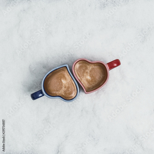 two cup of coffee in the heart form in the snow. New Year Christmas and winter concept. Instagram