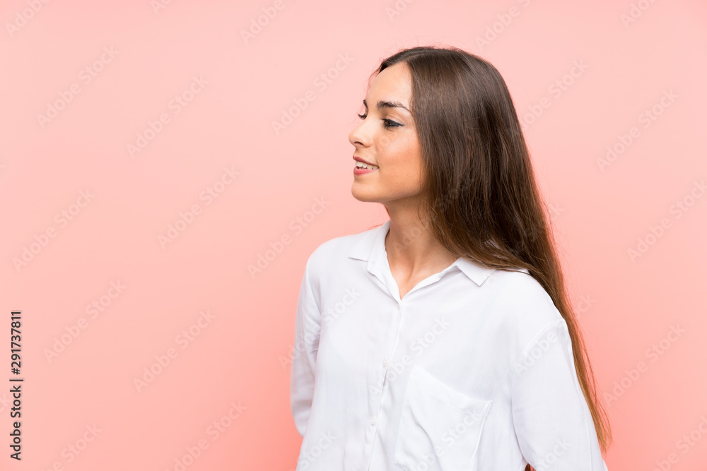 Young woman over isolated pink background looking to the side Young woman over isolated pink background looking to the side