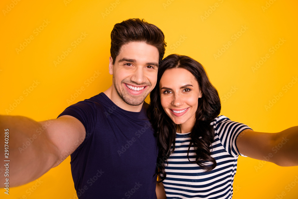 Self photo of toothily smiling lovely nice cute girl shooting themselves influencing people blogging while isolated with yellow background Self photo of toothily smiling lovely nice cute girl shooting themselves influencing people blogging while isolated with yellow background
