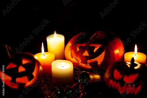 Halloween pumpkin and candles on a table with a straw