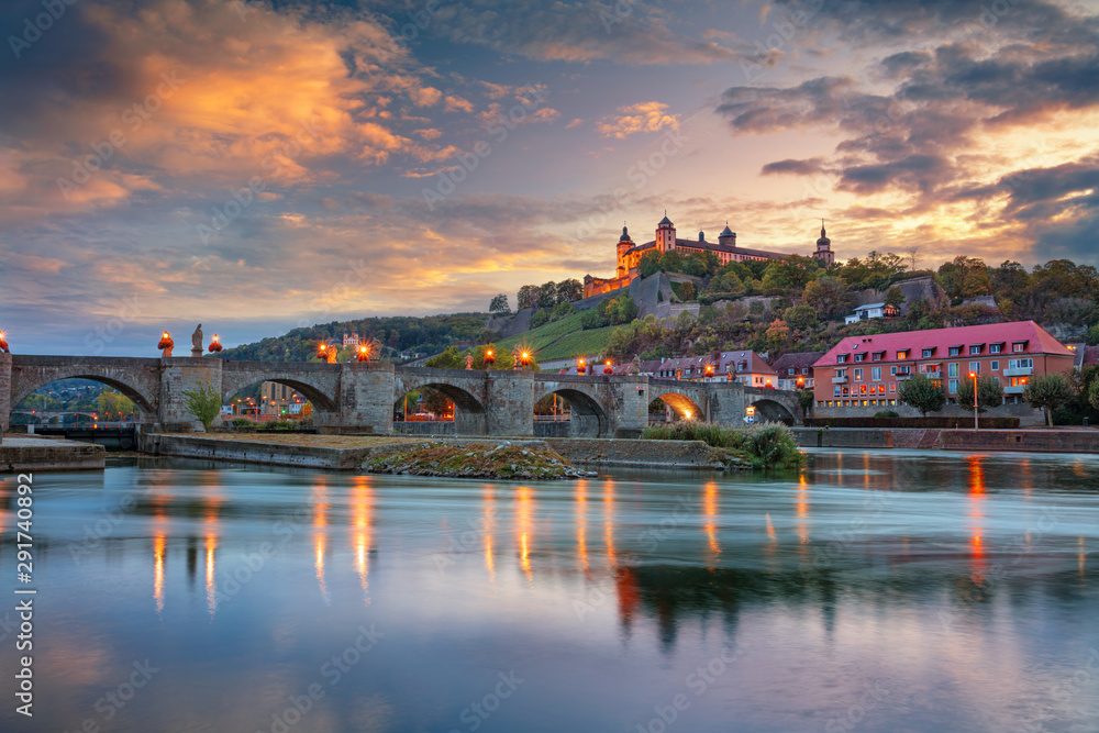 Wurzburg, Germany. Cityscape image of Wurzburg with Old Main Bridge over Main river and Marienberg Fortress during beautiful autumn sunset.