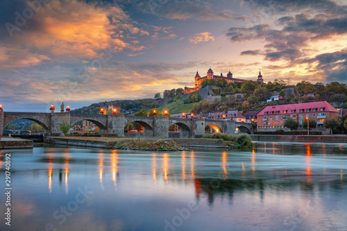 Wurzburg, Germany. Cityscape image of Wurzburg with Old Main Bridge over Main river and Marienberg Fortress during beautiful autumn sunset. photo