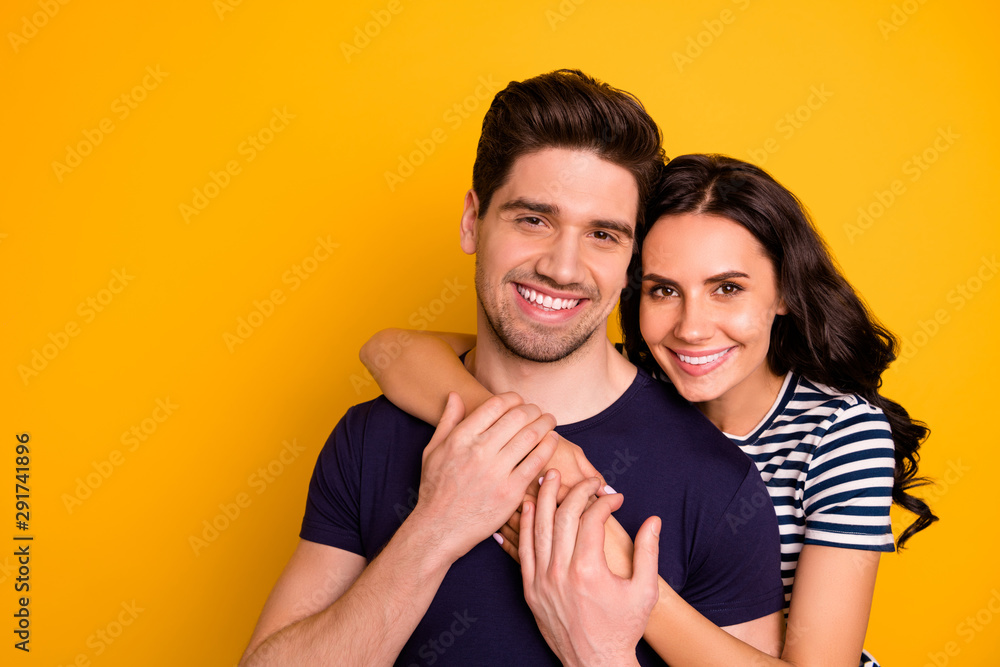 Photo of loving nice cute glad cheerful beautiful couple with girl hugging guy while isolated with yellow background Photo of loving nice cute glad cheerful beautiful couple with girl hugging guy while isolated with yellow background