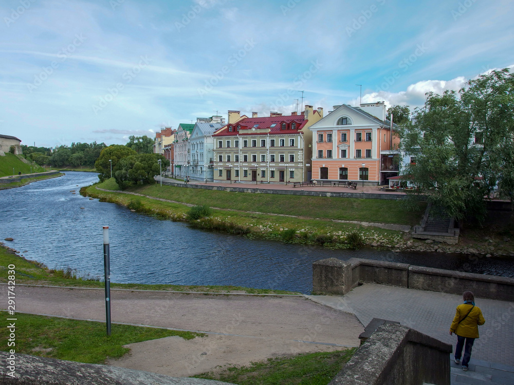 Old multi-colored houses on the banks of the river in the Russian city. Old multi-colored houses on the banks of the river in the Russian city.