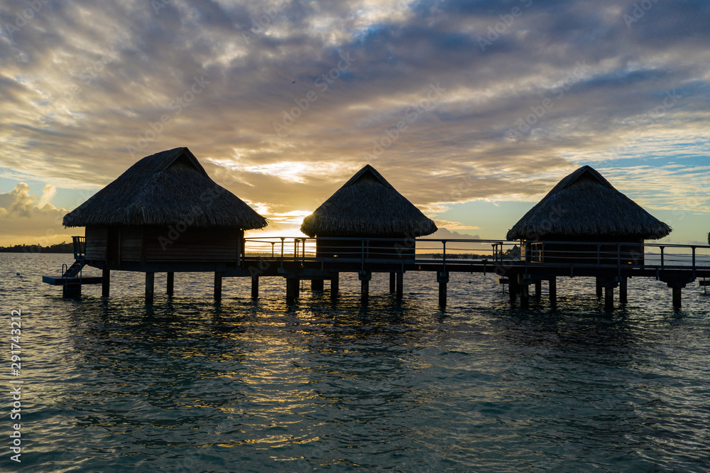 Luxury overwater villas during sunrise and Otemanu mountain at Bora Bora island, Tahiti, French Polynesia.