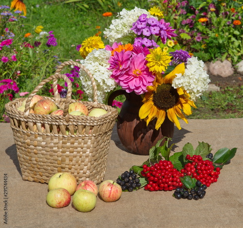 Wallpaper Mural Basket of apples, a bouquet of flowers in a jug and berries of viburnum and Rowan on the table in the garden Torontodigital.ca