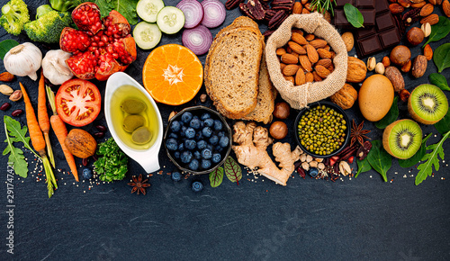 Ingredients for the healthy foods selection. The concept of healthy food set up on dark stone background.